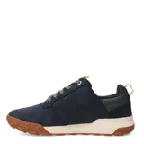Championes urbanos Caterpillar modelo Hex Ready Lo, color azul marino con suela de goma color caramelo y entresuela beige. Presenta detalles en color crema en la lengüeta y el talón, con cordones jaspeados y logo de la marca en el lateral.