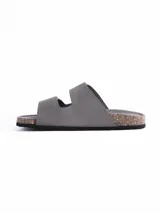 Sandalia de dos tiras con cierre de velcro, confeccionada en material símil cuero color gris. Cuenta con plantilla anatómica con base de corcho y suela de goma negra.