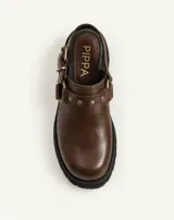 Zueco de cuero vacuno color chocolate, marca Pippa, con taco de 4,5 cm, detalles de herrajes en tono oro viejo, estribo y tachas decorativas.