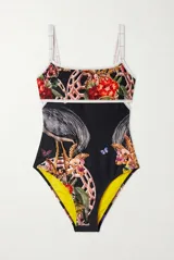 Malla enteriza de color negro con estampado multicolor de aves, flores y mariposas, tirantes finos blancos y ribetes contrastantes.