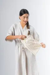 Bata kimono corta color beige, confeccionada en tela waffle de algodón. Tiene mangas al codo, lazo de ajuste en la cintura y detalle de vivo en la solapa.