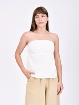 Top strapless de lino blanco con diseño ajustado en el busto y corte evasé en la parte inferior.