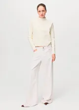 Sweater de punto fino color blanco off-white, con cuello perkins y manga larga, de corte recto.