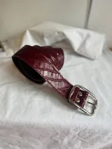 Cinto de cuero con hebilla metálica dorada.