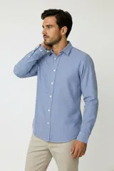 Camisa de algodón de manga larga con diseño de rayas verticales en tonos gris y blanco, cuello camisero clásico y cierre frontal con botones.