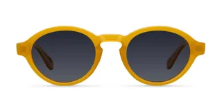 Lentes de sol con montura redonda de estilo retro en color ámbar y lentes polarizadas oscuras. Fabricados con materiales bio-based y propionato de celulosa, cuentan con protección UV400 y recubrimiento resistente a rayones.
