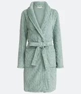 Bata corta en color verde agua, confeccionada en fleece con textura en relieve. Tiene mangas largas, cuello tipo chal y lazo para ajustar en la cintura.