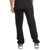 Pantalón de jogging DC Shoes modelo Clewiston, color negro con estampa vertical en contraste con el nombre de la marca en la pierna, puños elásticos en los tobillos y bolsillos laterales.
