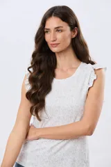 Musculosa blanca con estampado floreado sutil y volados en los hombros, de corte recto.