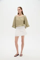 Minifalda blanca de viscosa con diseño cruzado y frunces en la cintura.