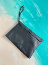 Sobre de mano Carolina de Cunto de cuero negro con diseño artístico pintado a mano en la solapa, mango corto de mano y cierre con broche magnético.