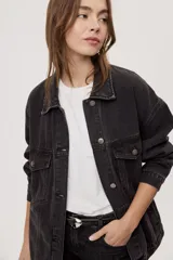 Campera de jean de silueta amplia, con cuello clásico y cierre frontal con botones. Diseño con bolsillos con solapa en el frente y bolsillos laterales, hombros caídos y terminaciones pespunteadas.