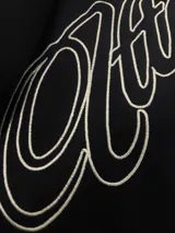 Hoodie negro con capucha y estampa gráfica blanca en la espalda con diseño tipográfico cursivo. Presenta puños y ruedo acanalados.