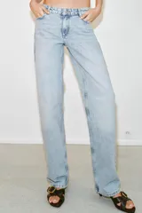 Jeans de tiro bajo con diseño de cinco bolsillos y pernera recta. Cierre frontal con cremallera y botón metálico.
