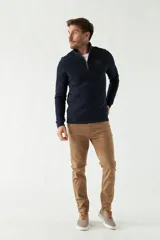 Buzo de felpa azul marino para hombre con medio cierre frontal, logo estampado en el pecho y puños. El modelo mide 1,80 m y usa talle M.