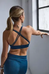 Top deportivo negro con espalda cruzada en cuatro tiras y almohadillas removibles.