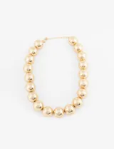 Collar corto de esferas doradas con cierre de mosquetón. Pieza de la colección cápsula SYMPHORINE X VIC SARAVIA.