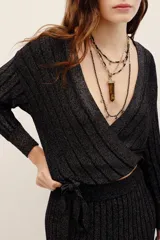 Cardigan cruzado de punto con hilo metalizado, color negro, de manga larga y escote en V profundo.