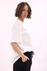 Remera blanca de manga corta, corte oversize, con estampa colorida de motivos marinos y botánicos en el frente.