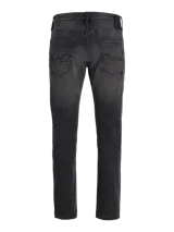 Jean tapered de hombre color negro con acabado lavado, tiro bajo y diseño clásico de cinco bolsillos.