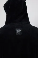 Poncho de toalla con capucha en color azul marino, confeccionado en 100% algodón. Presenta un bordado blanco del logo de Rusty en el pecho.