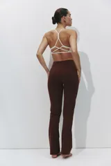 Leggings deportivos acampanados de color marrón, tiro alto y diseño ajustado con perneras amplias hacia el dobladillo.