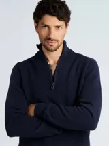 Sweater de punto panal color azul marino, con cuello alto y cierre frontal parcial. Presenta puños y ruedo acanalados.