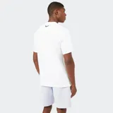 Remera deportiva de manga corta, color azul claro, con cuello redondo y un bolsillo abierto en el pecho. Presenta una costura horizontal que cruza el pecho y el logo de la marca en el frente.