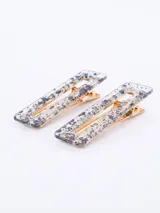 Set de dos broches rectangulares para el pelo con diseño de carey en tonos crema y blanco, y gancho dorado.