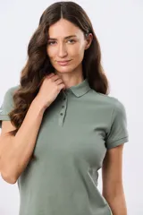 Remera polo lisa de piqué en color verde militar, con mangas cortas y cierre frontal de botones.