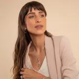 Collar de plata 925 con cadena fina tipo veneciana y un dije colgante de diseño geométrico en forma de ojo o hoja estilizada, compuesto por dos siluetas entrelazadas, una de ellas con detalles de brillo.