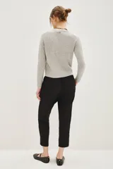 Pantalon estilo babucha color mostaza, con cintura elástica y cordón de ajuste, bolsillos diagonales frontales y terminaciones ajustadas en los tobillos.