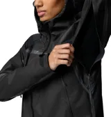 Campera impermeable de mujer Columbia modelo Whistler Peak Shell OutDry, en color negro con detalles reflectantes y costuras selladas. Cuenta con capucha ajustable, cremalleras frontales y laterales de poliuretano, y aberturas de ventilación.