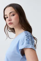 Remera de algodón color celeste melange, con cuello en V y mangas cortas con dobladillo.