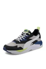 Championes deportivos Puma modelo X-Ray Duo Speed, con diseño multicolor que combina blanco, negro, azul y detalles en verde lima. Confeccionados en malla y materiales sintéticos, con cordones blancos y suela robusta.