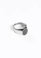 Anillo plateado de acero quirúrgico con piedra negra sintética.