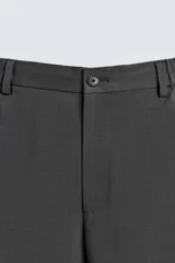 Pantalón de corte relaxed fit, con cintura ajustable, bolsillos delanteros y bolsillo trasero de plastrón. Presenta cierre frontal con cremallera y botón.