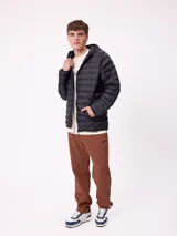 Pantalón tipo babucha de algodón y poliéster en color marrón, con cintura elástica, bolsillos laterales y logo de la marca bordado en la pierna izquierda.