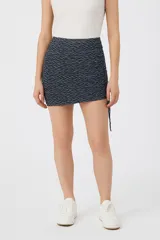 Minifalda azul con estampado geométrico en blanco, de poliéster y corte ajustado.