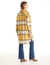 Sobrecamisa larga de tejido soft con estampado de cuadros en tonos celestes, beige y blanco. Presenta cuello con solapa, cierre frontal con botones, bolsillos aplicados en el pecho y mangas largas con puños abotonados.