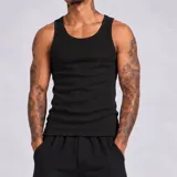 Musculosa tank de corte slim, color negro, con diseño acanalado de líneas simples.