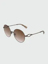 Lentes de sol Longchamp con armazón metálico dorado y diseño de eslabones en las patillas. Presentan cristales redondos con degradado en tonos marrones.