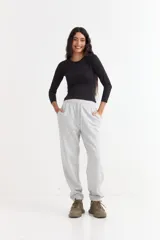 Pantalón jogger de felpa color marrón, con cintura elástica ajustable mediante cordón, bolsillos laterales y puños elásticos en los tobillos.