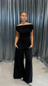 Top negro con escote off-shoulder y brillos.