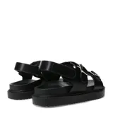 Sandalias de plataforma plana Miss Carol modelo Naira, color negro con doble tira ajustable con hebillas metálicas plateadas y suela dentada.