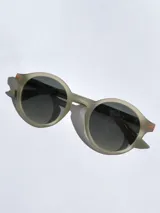 Lentes de sol Osten modelo Niza con armazón redondo de acabado mate en color mostaza y cristales oscuros polarizados con protección UV 400.