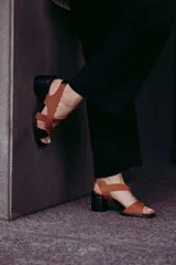 Sandalias de cuero color marrón y negro, con tiras cruzadas y taco de 6 cm.