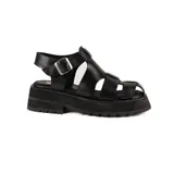 Sandalias negras de cuero con plataforma y tiras anchas entrecruzadas.