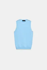 Jersey de punto azul marino sin mangas, con cuello redondo, ribetes en contraste y detalles de botones dorados en el hombro.