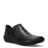 Zapatos casuales de cuero negro con cierre lateral metálico y costuras decorativas en contraste. Presentan una suela plana de goma con diseño ergonómico y forro interior en color marrón.